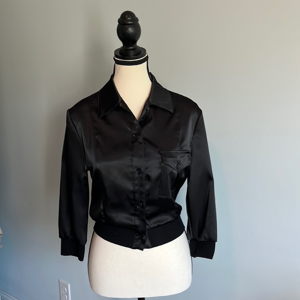 Black satin feel top. Elastic on bottom/waist and bottom of arms. 3/4 arm length